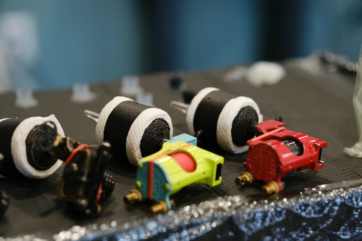 Wrapped tattoo machines lined up on a station before a session